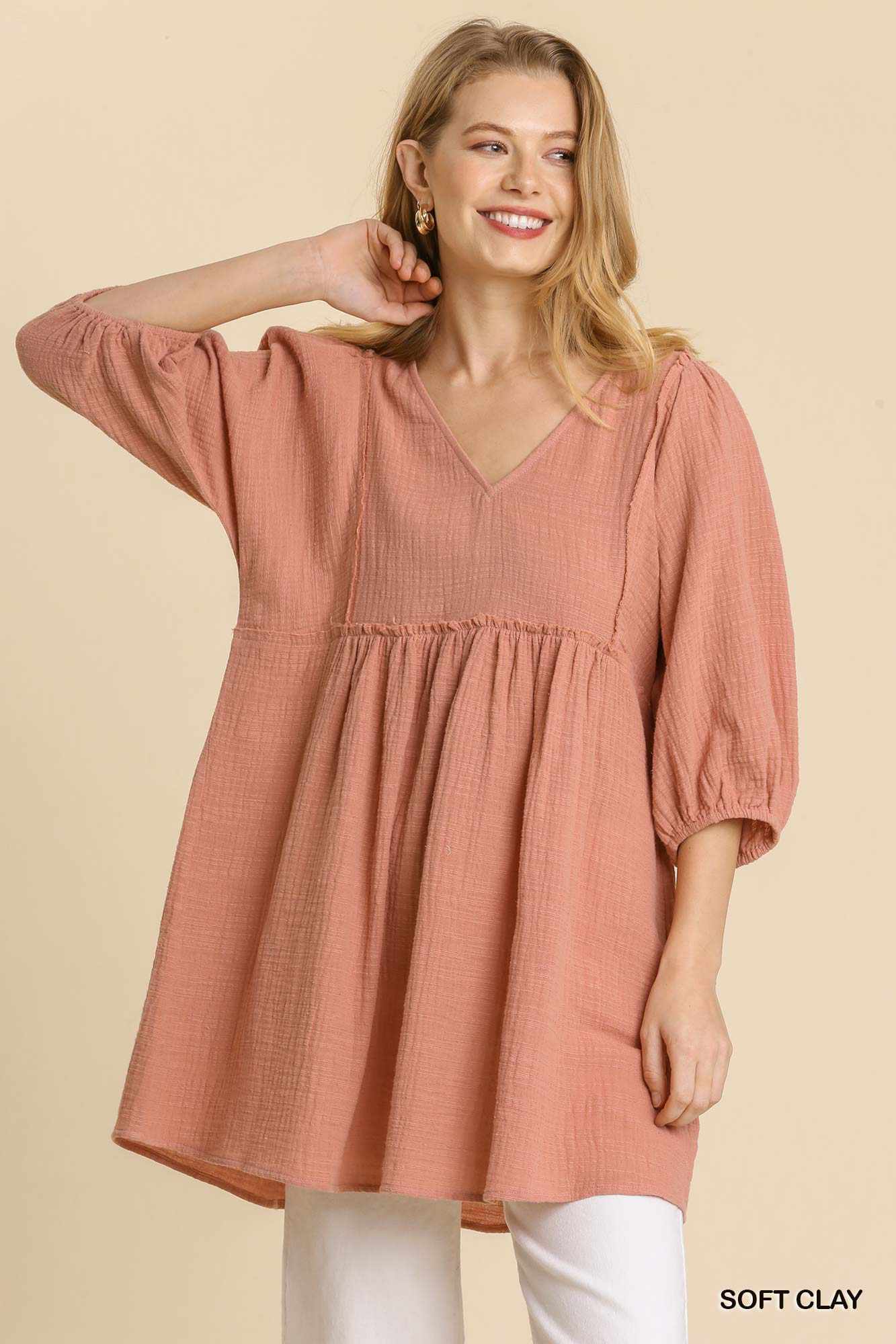 Woman wearing a soft clay Gauze Slub V-neck Tunic Dress with frayed edge detail and ruched front.