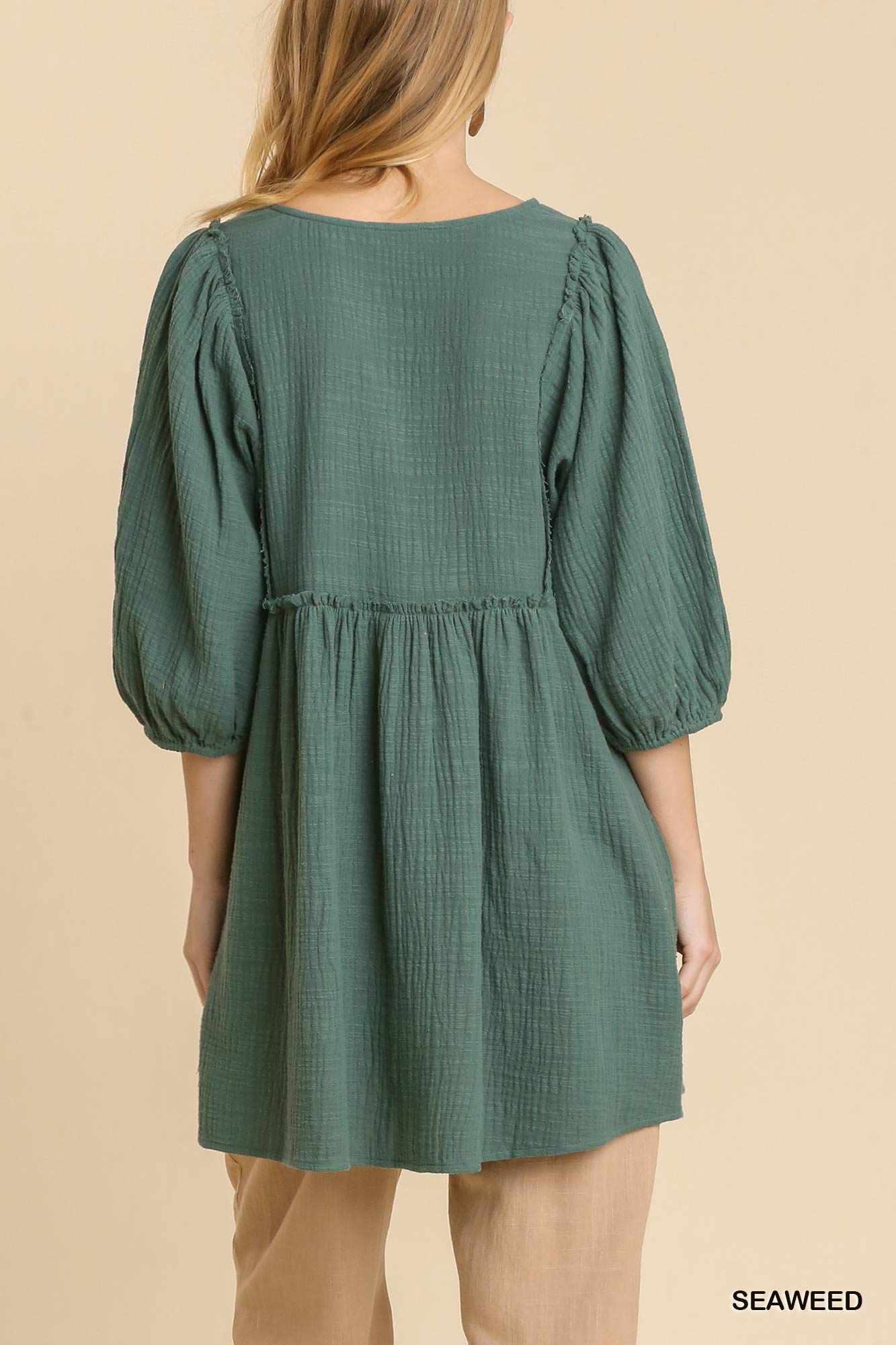 Green gauze slub V-neck tunic dress with frayed edge detail in seaweed color, featuring a relaxed fit and puff sleeves.