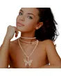 Woman wearing gold butterfly choker set with layered necklaces.