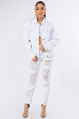 Woman wearing graphic distressed long sleeve denim jacket with ripped jeans, showcasing trendy and edgy fashion style.