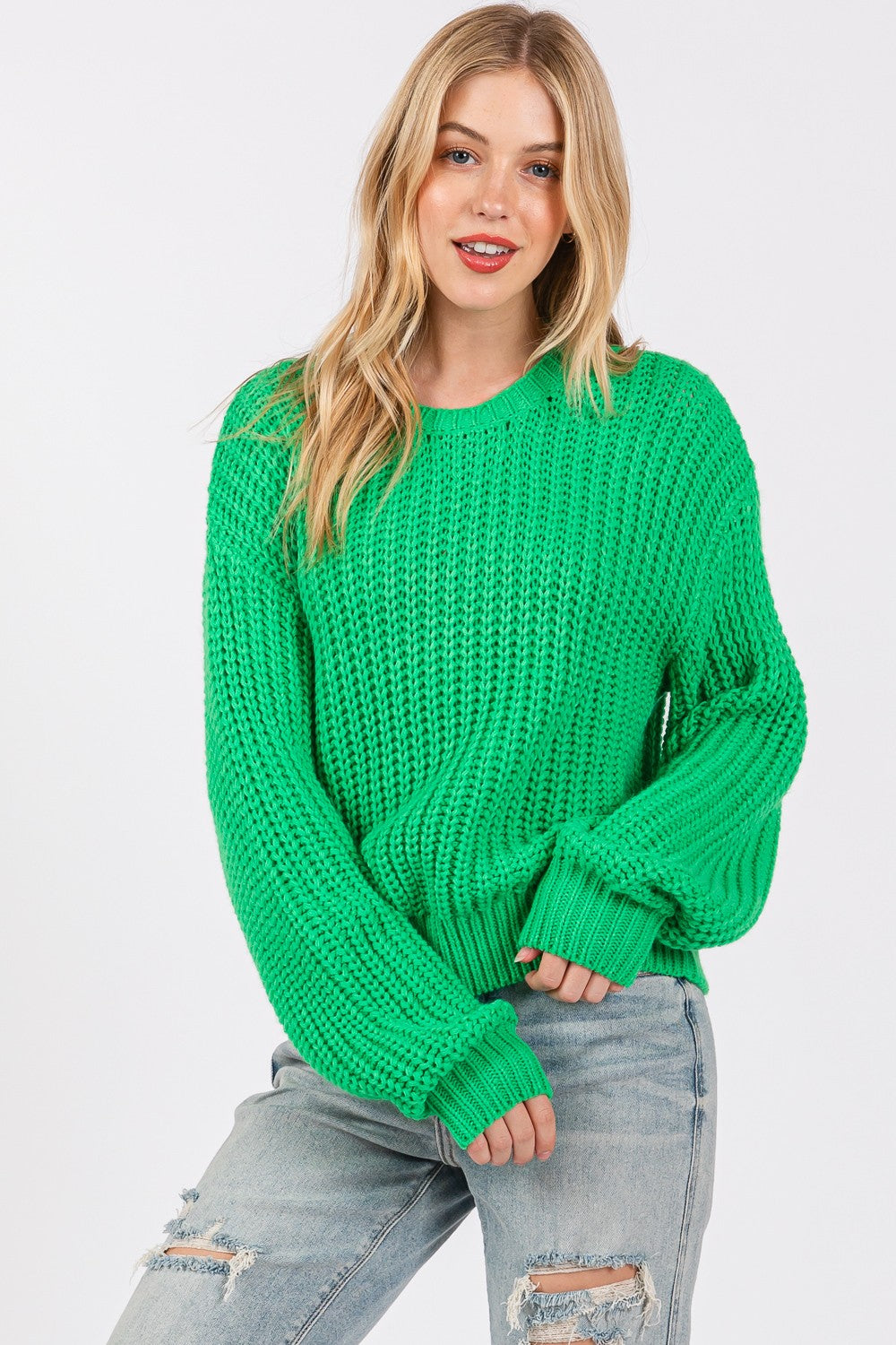 Green round neck drop shoulder sweater made of 100% acrylic, slightly stretchy for a comfortable fit, worn by a model with distressed jeans.