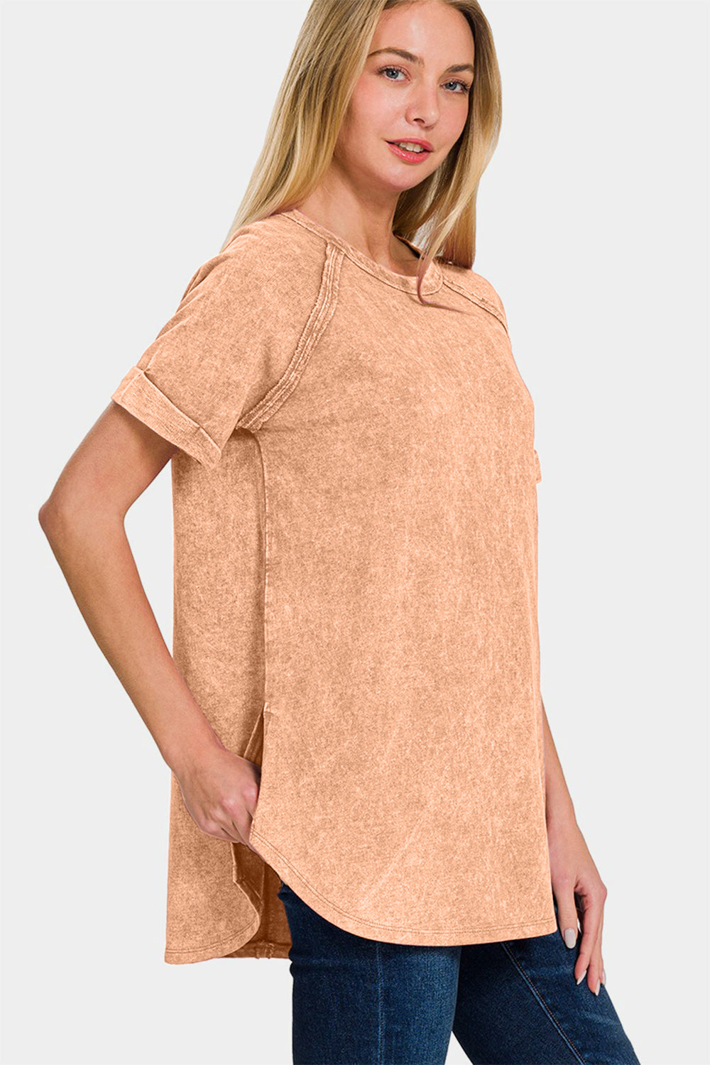 Woman wearing heathered round neck short sleeve top in peach, 100% cotton, opaque with moderate stretch, casual basic style.