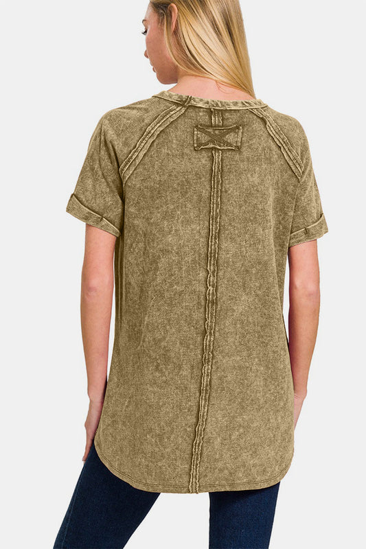 Woman wearing a heathered round neck short sleeve top in olive, featuring moderate stretch and 100% cotton composition.