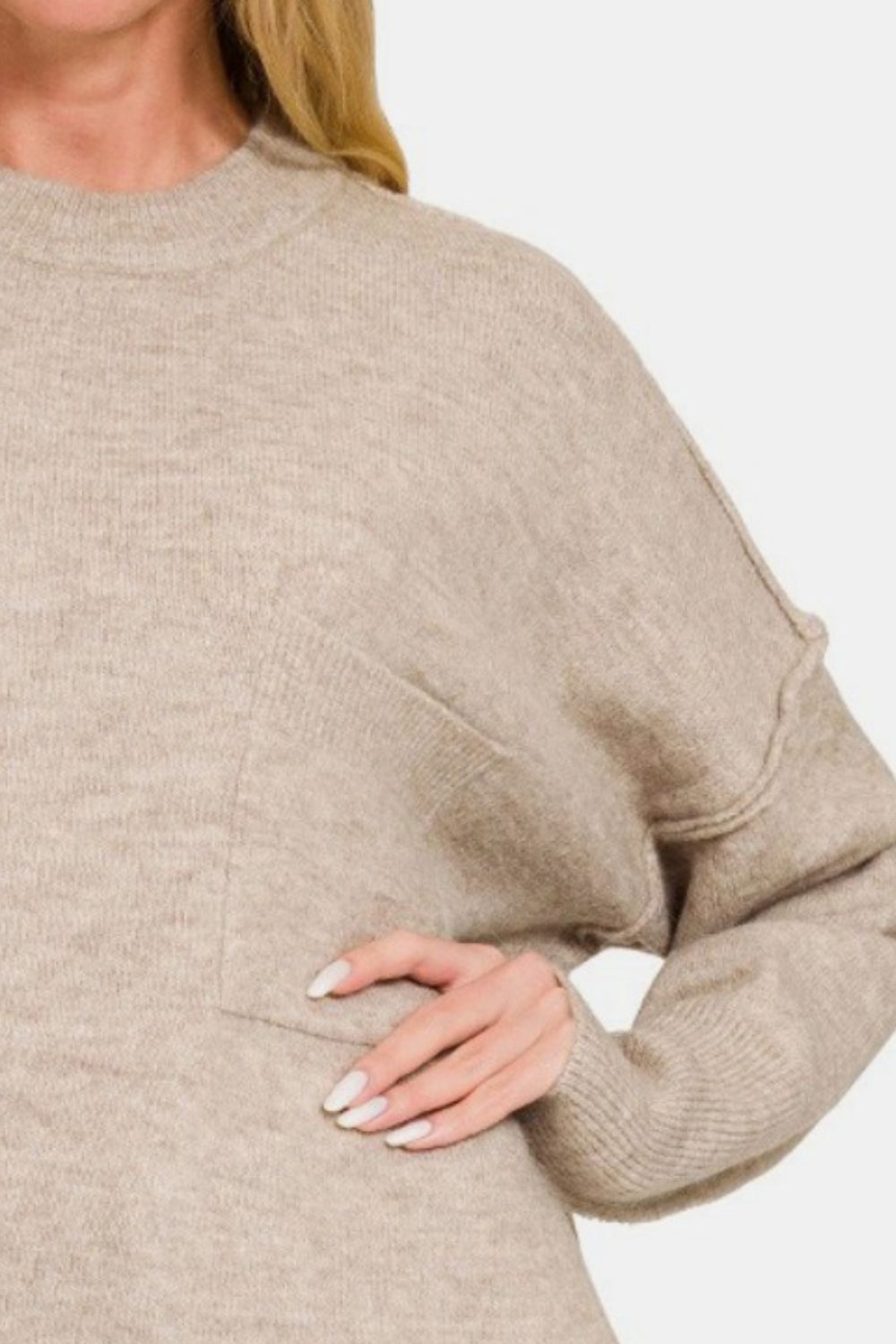 High-low hem drop shoulder sweater with exposed seams, showcasing cozy midweight fabric and flattering fit in beige tone.