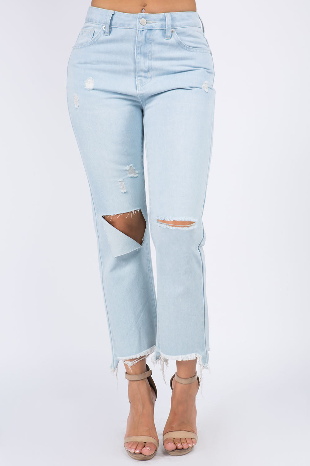 High waist distressed raw hem jeans in light denim with ripped details, featuring a trendy style and comfortable cotton fit.