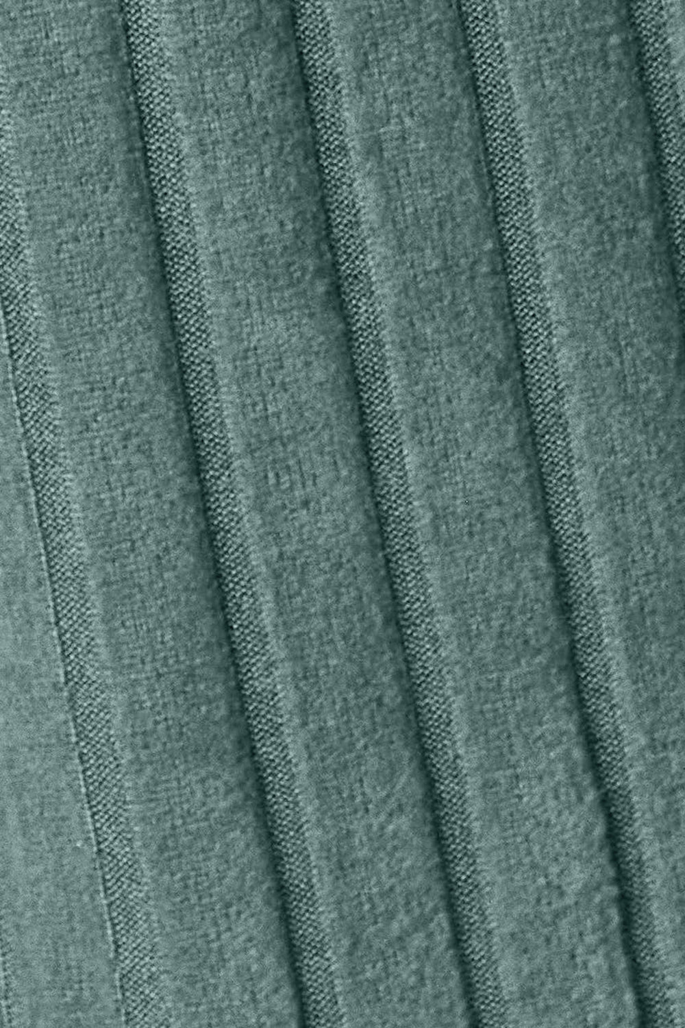 Close-up of green ribbed fabric texture showing detailed vertical pattern on a slightly stretchy garment.