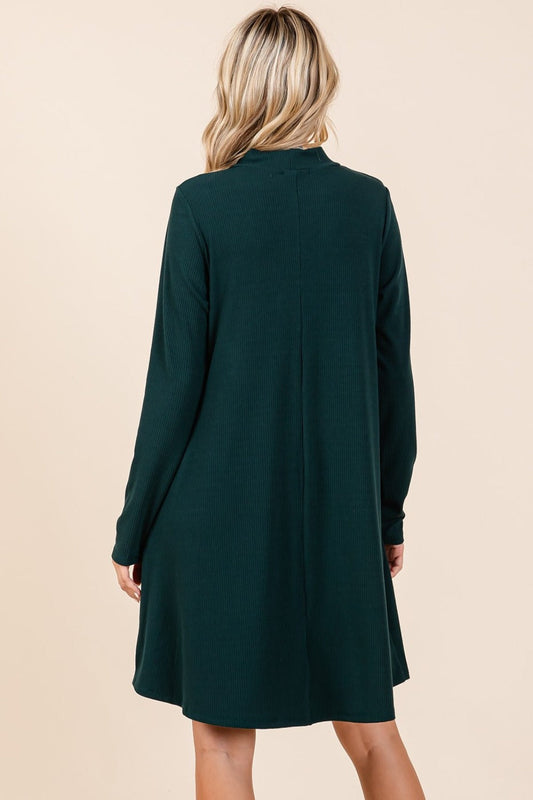 Hunter green mock neck long sleeve dress with pockets, shown from the back, slightly stretchy polyester-rayon-spandex blend.