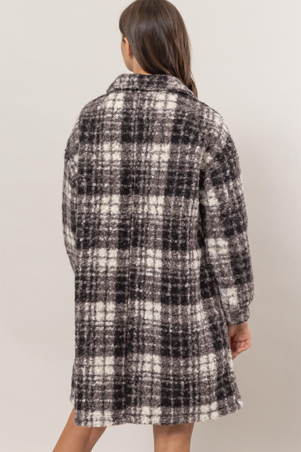 Woman wearing HYFVE plaid button down longline shacket with collar and drop shoulders, showcasing the back design.