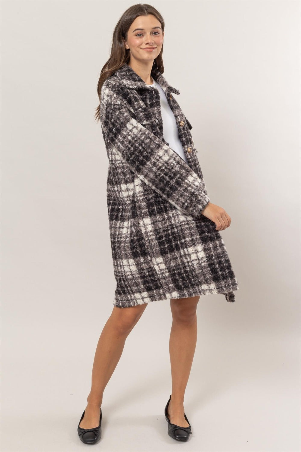 Woman wearing HYFVE plaid button down longline shacket with drop shoulders and chest flap pockets.