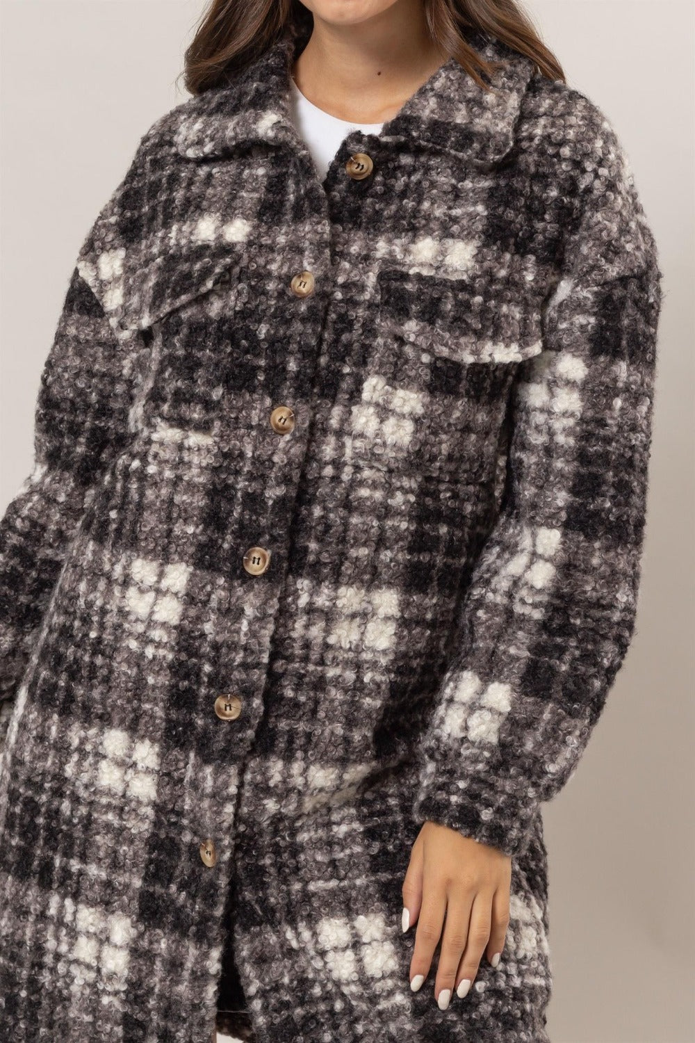 Woman wearing HYFVE plaid longline shacket with button-down front and chest pockets, featuring a stylish bouclé texture.