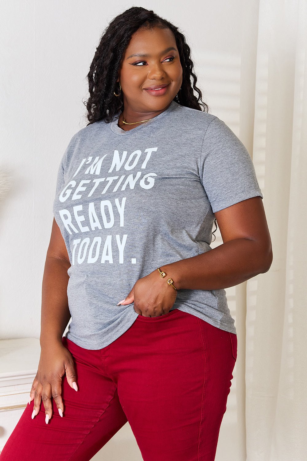 Woman wearing "I'm Not Getting Ready Today" graphic t-shirt, featuring a comfortable, wrinkle-resistant polyester blend with spandex.