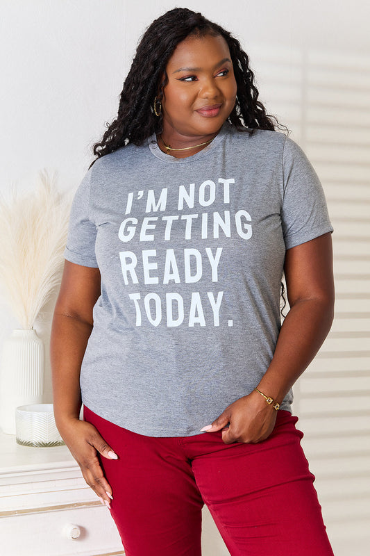 Woman wearing gray "I'M NOT GETTING READY TODAY" graphic T-shirt and red pants, showcasing comfortable and stylish casual wear.