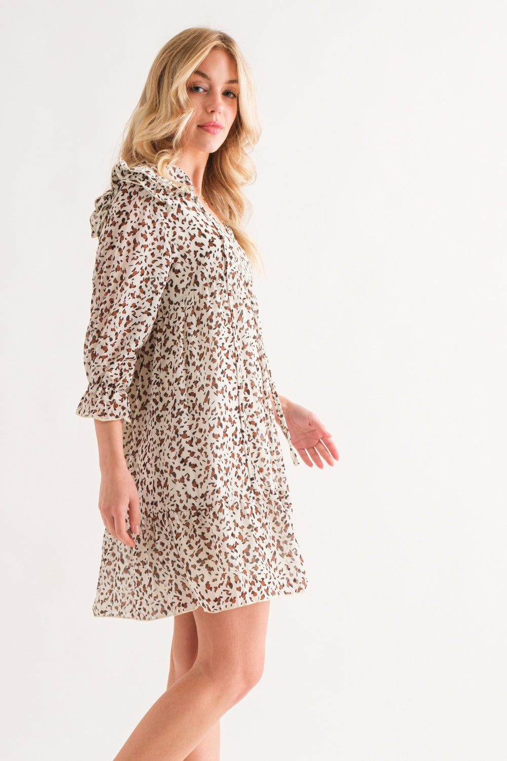 Ivory leopard ruffle hem woven mini dress with ruched design, slightly stretchy and opaque, made of 95% polyester and 5% spandex.