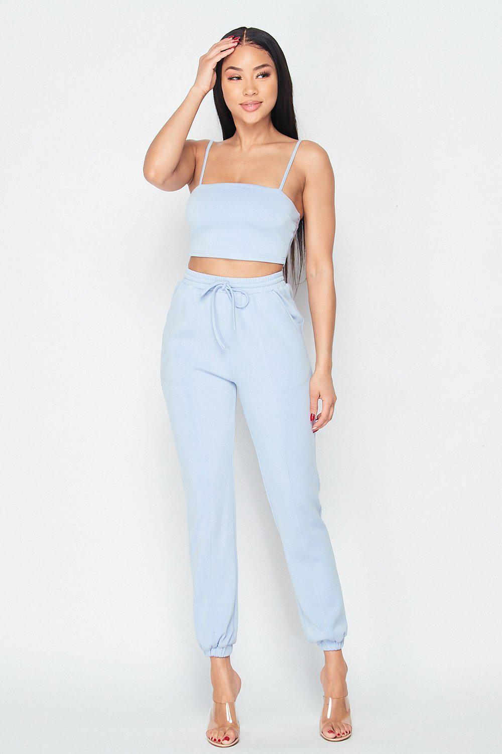 Woman wearing Keep It Cute two-piece set in light blue, featuring a fitted top and drawstring pants, perfect for stylish comfort.