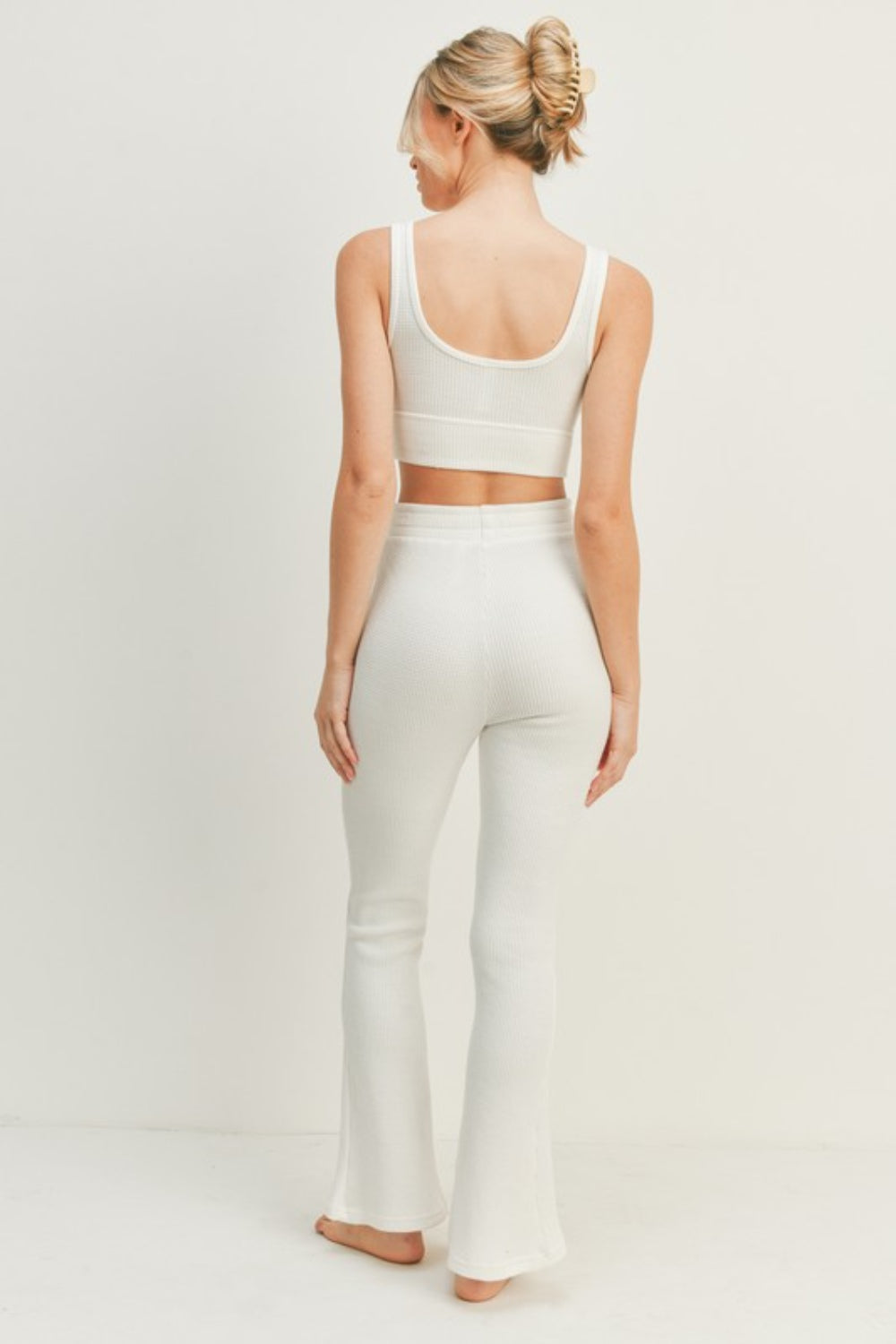 Woman wearing Kimberly C White Waffle Tank and High Waist Flare Pants Set, showcasing back view and comfortable fit.