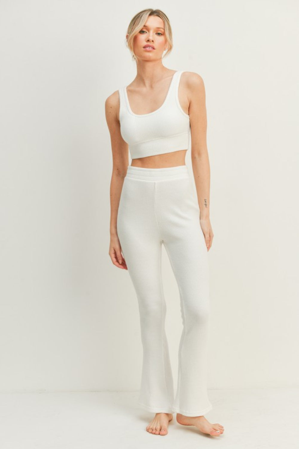 Kimberly C White Waffle Tank and High Waist Flare Pants Set showcasing stylish and comfortable lounge wear in soft knit fabric.