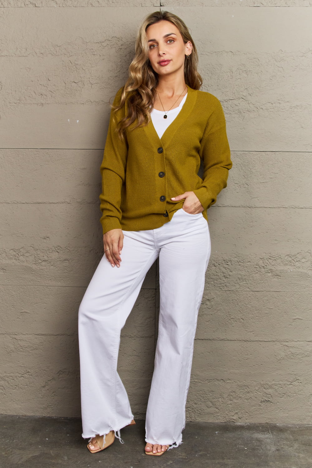 Woman wearing Kiss Me Tonight Chartreuse Cardigan with white outfit, casual button-down style, ribbed v-neck, long sleeves.