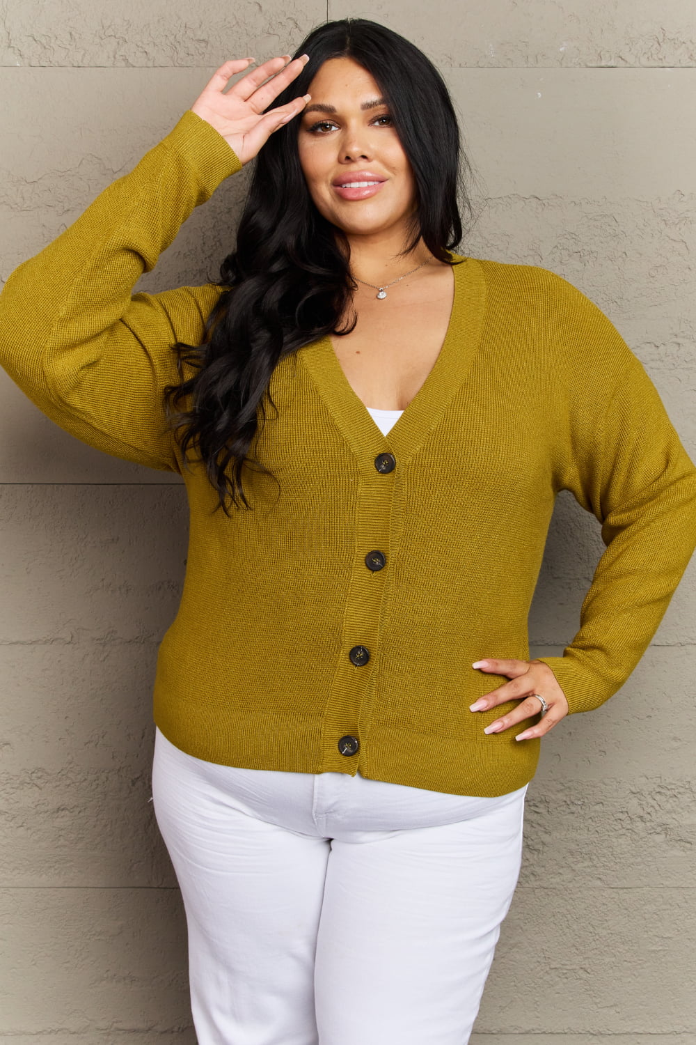 Woman wearing Kiss Me Tonight chartreuse cardigan, button down, ribbed V-neck, long sleeves, casual style.