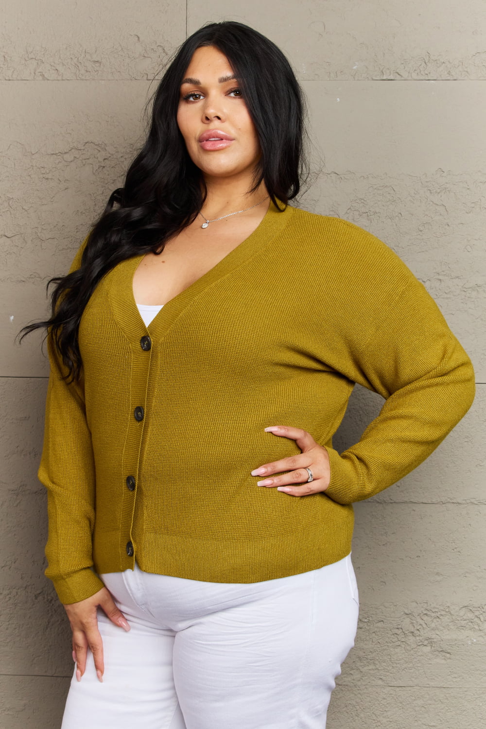 "Woman wearing Kiss Me Tonight full size chartreuse cardigan, featuring a solid pattern and V-neck style with long sleeves"