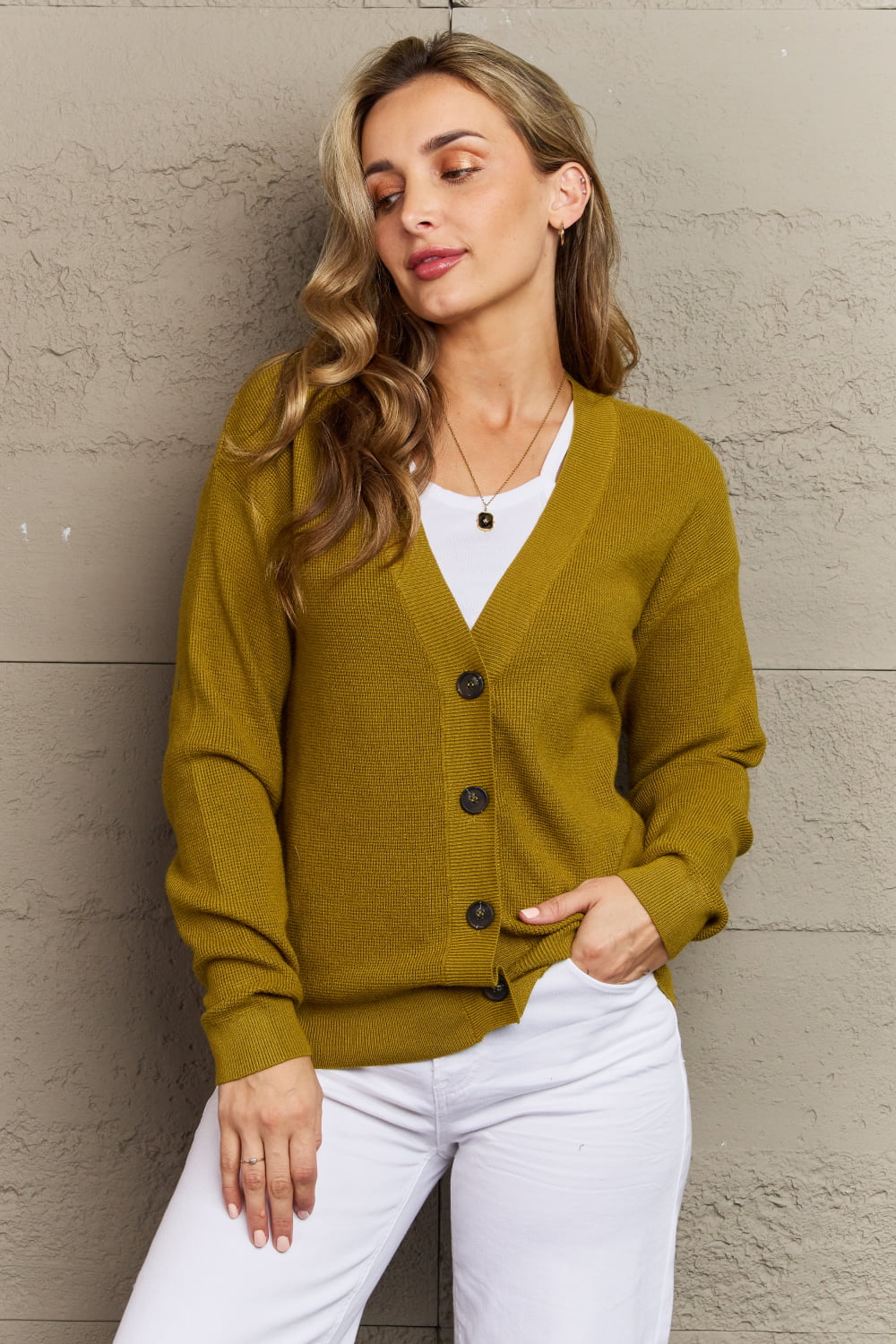 Woman wearing chartreuse Kiss Me Tonight Cardigan, solid button-down style with long sleeves and V-neck, casual look.