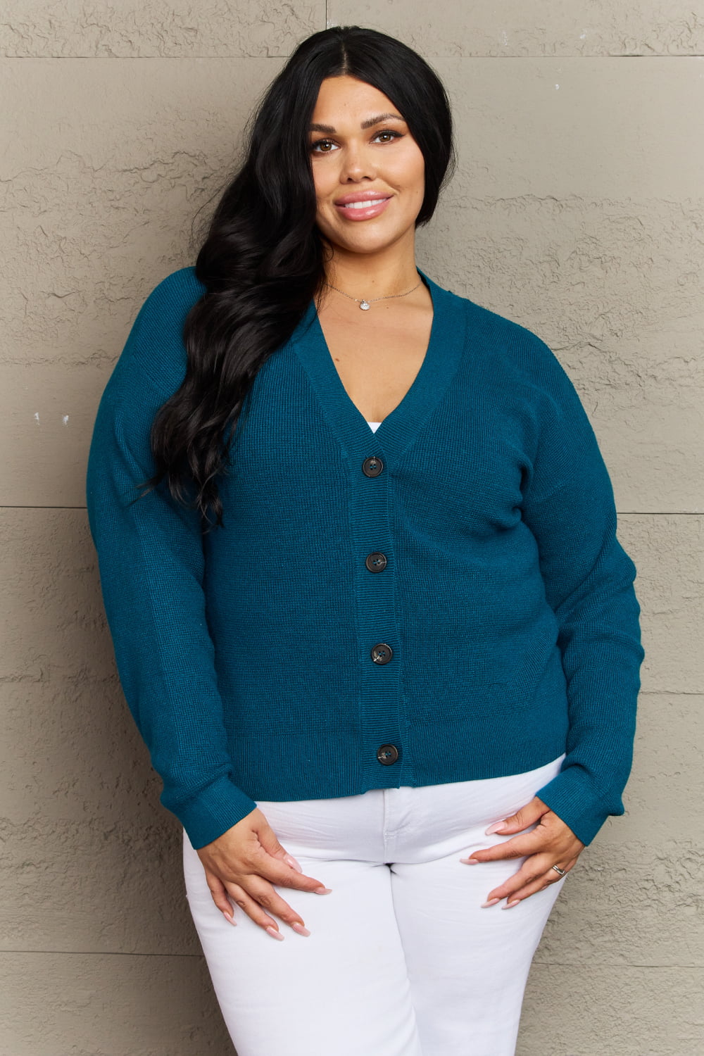 Woman wearing Kiss Me Tonight Full Size Cardigan in Teal with long sleeves and V-neck, casual ribbed design, button-down style.