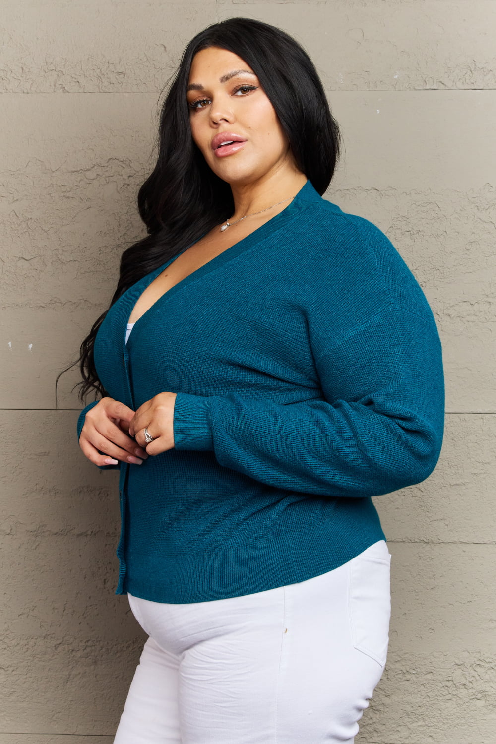 Woman wearing Kiss Me Tonight full size teal cardigan with V-neck and long sleeves, showcases casual style and ribbed design.