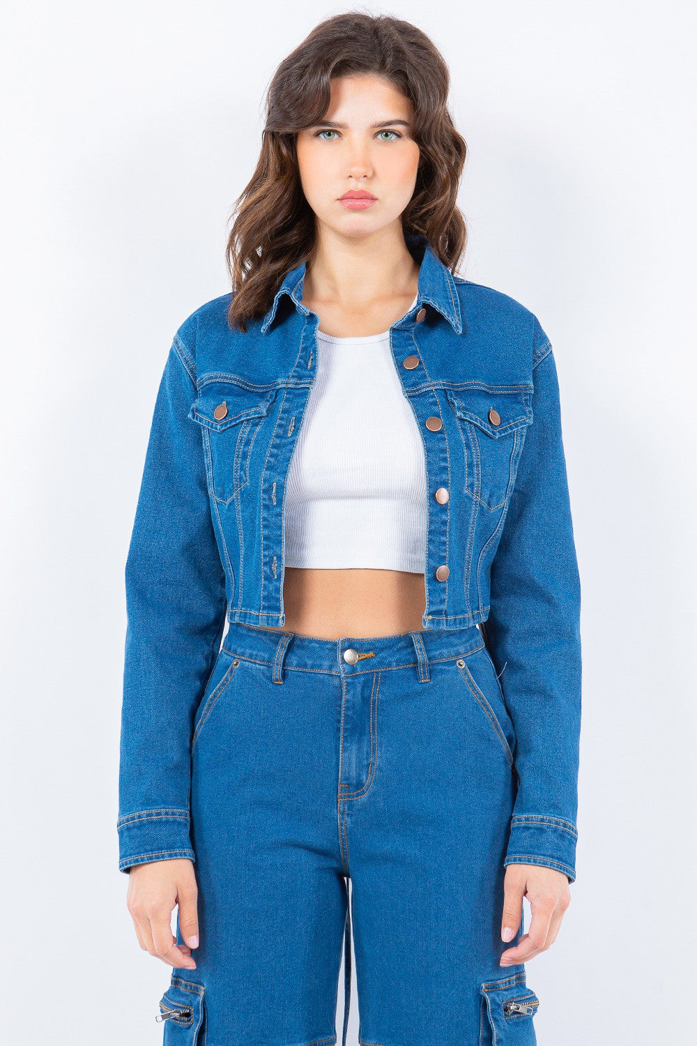 Trendy laced back cropped denim jacket with button accents, ideal for versatile casual or dressy wear.