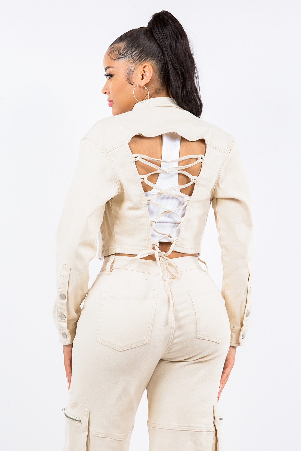 Stylish lace back cropped jacket with button details in beige, perfect for pairing with high-waisted jeans for a chic look.