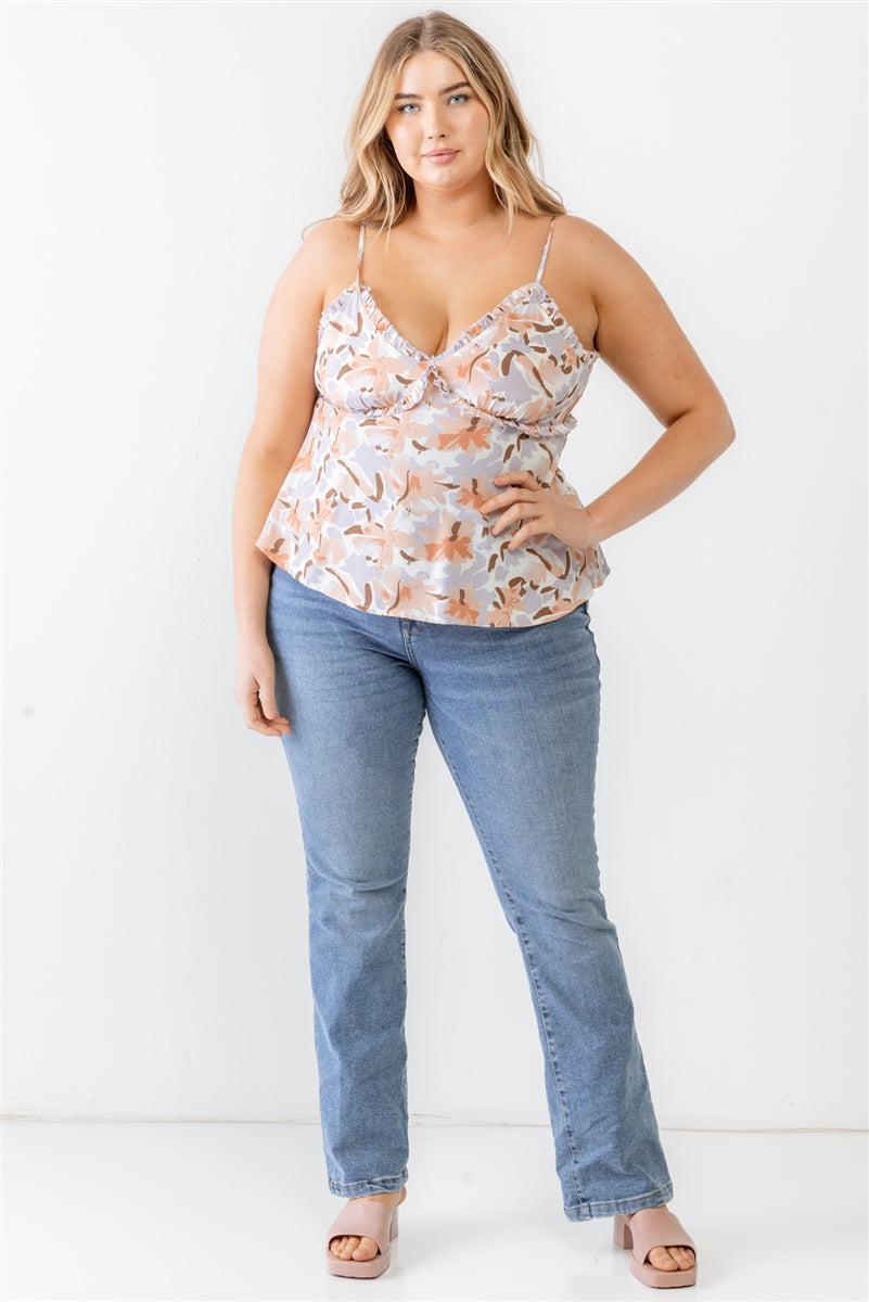 Plus size model wearing lavender floral print woven tank top with ruffles and adjustable straps, paired with blue jeans.