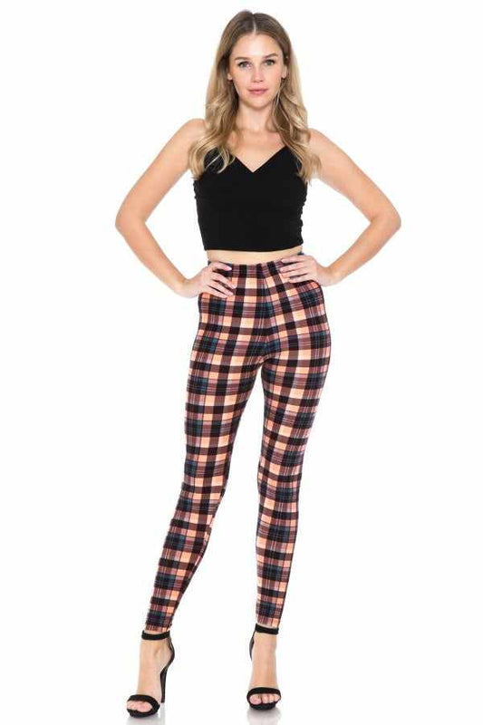 Multi-printed high-waisted leggings with elasticized waistband, featuring a plaid design, worn with a black top and heels.