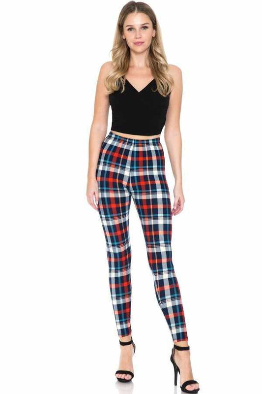 Stylish woman wearing multi-printed high-waisted leggings with elasticized waistband, paired with black top and heels.