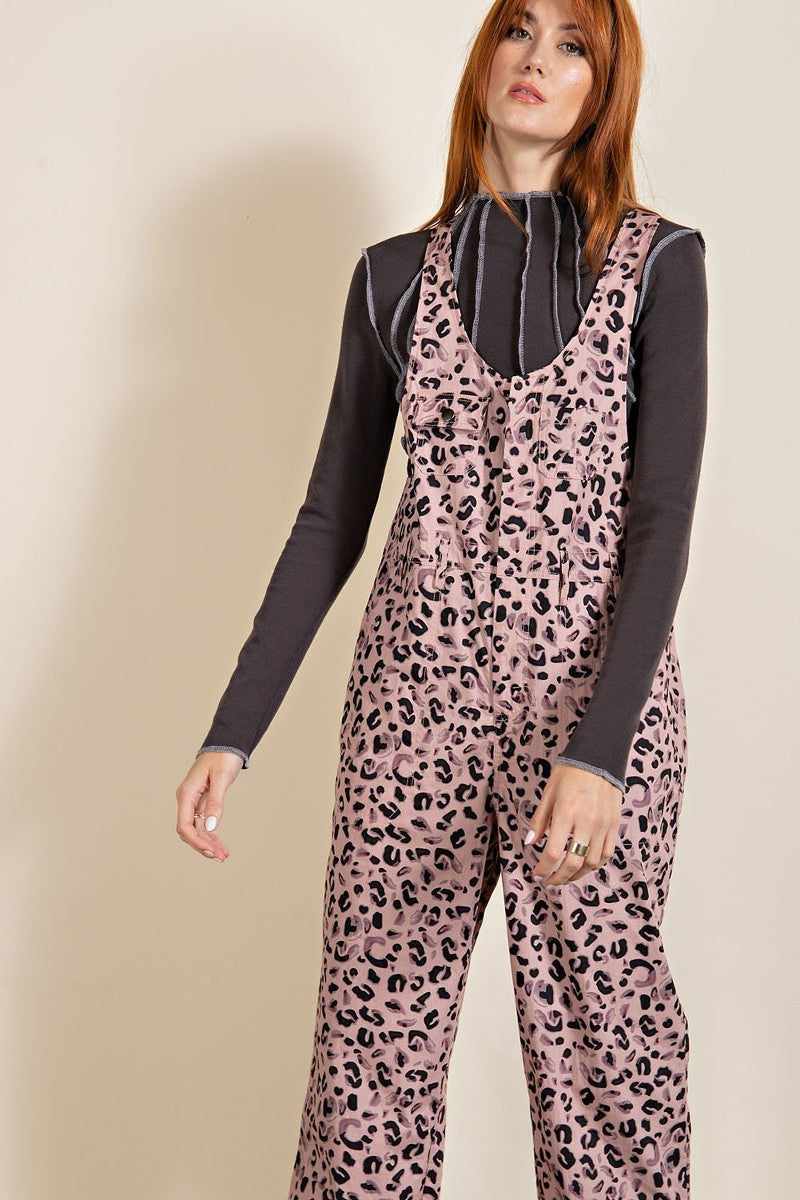 Stylish mauve leopard printed jumpsuit with U-shaped neckline, chest pockets, and racer-back design made from 100% cotton.