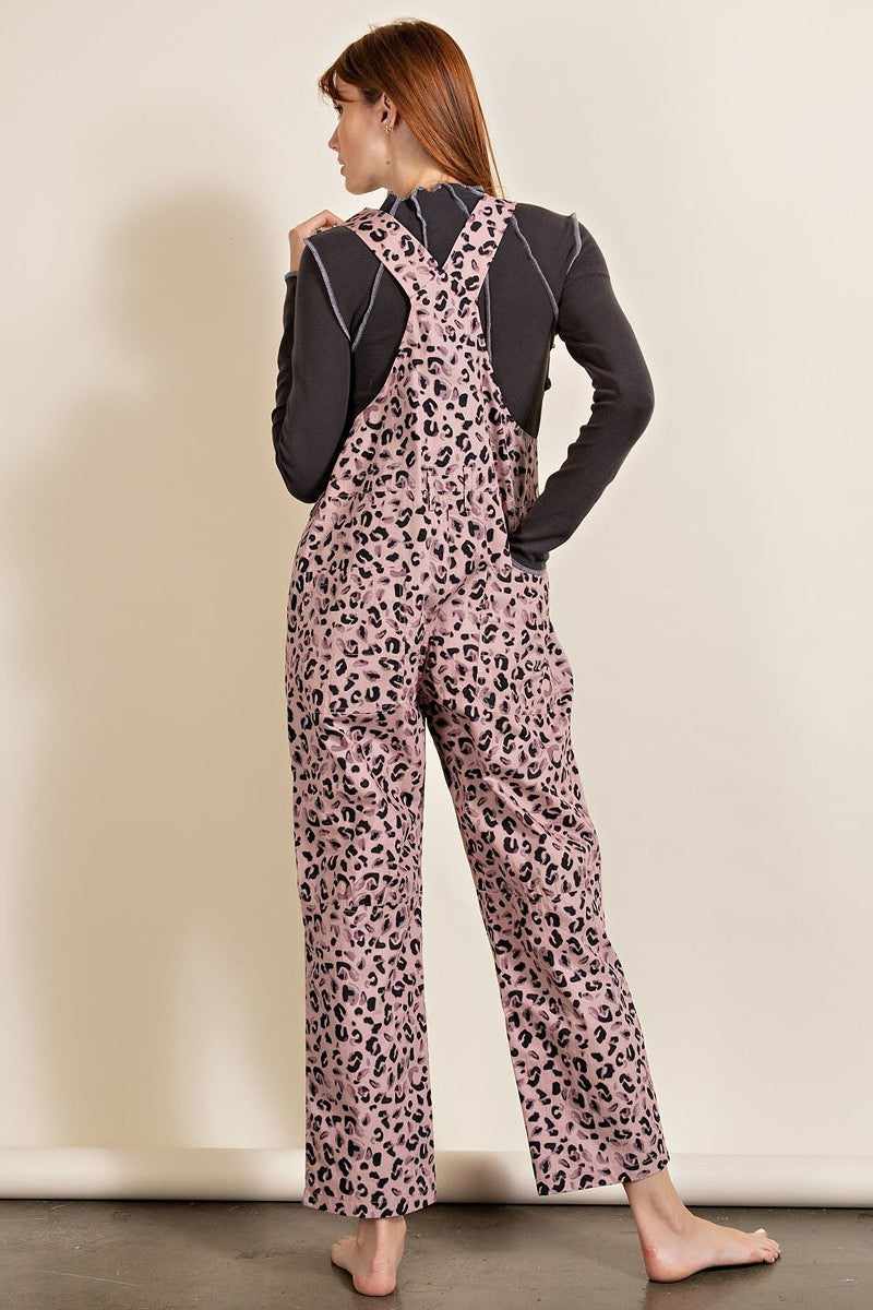 Mauve leopard print jumpsuit with relaxed fit, racer-back style, and patch pockets. Made from 100% cotton.