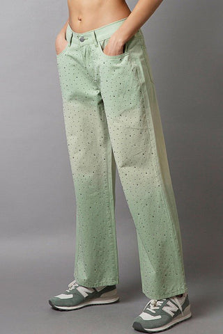 Light green gradient wide-leg pants with rhinestone embellishments and pockets, made from 100% cotton, worn with sneakers.