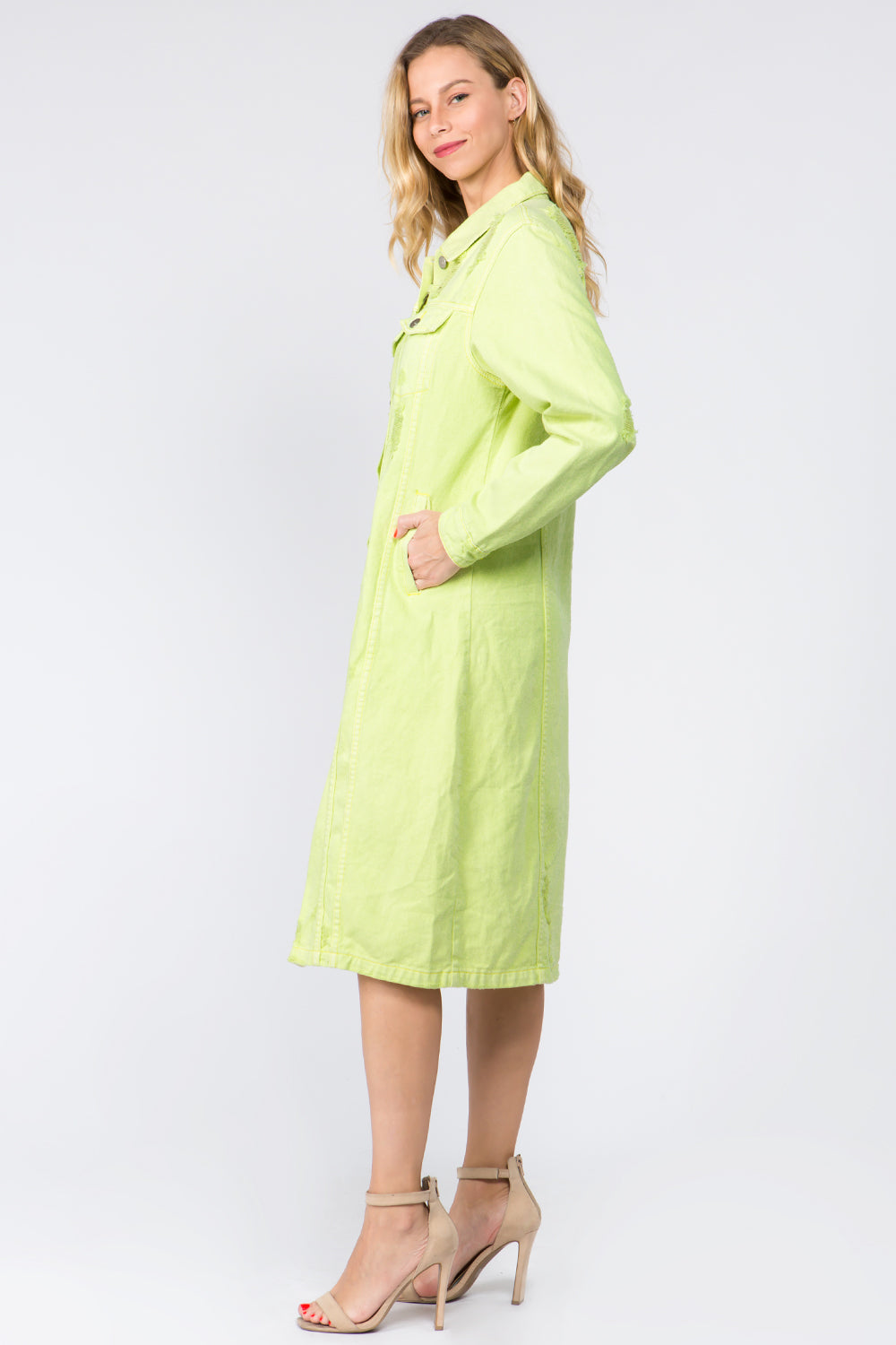 Lime button-up distressed denim dress, long sleeve, 100% cotton, side view on a model with neutral heels.