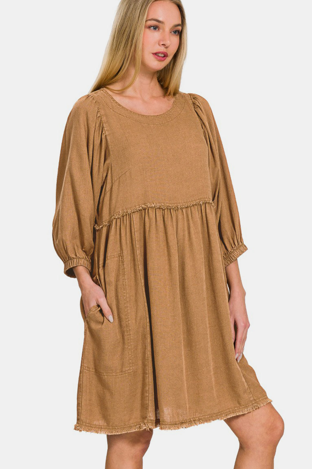 Washed linen pleated puff sleeve babydoll dress with ruched design and pockets, made of 25% linen and 75% rayon.