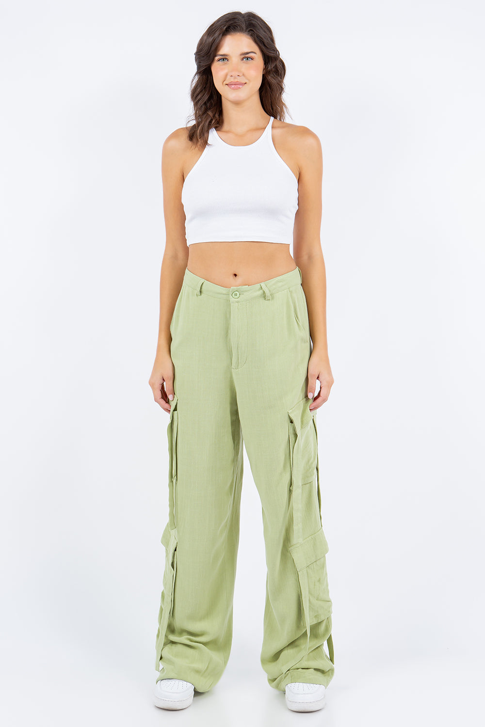 Woman wearing linen wide leg cargo pants, fashionable and versatile, made from a soft, lightweight blend of rayon and linen.