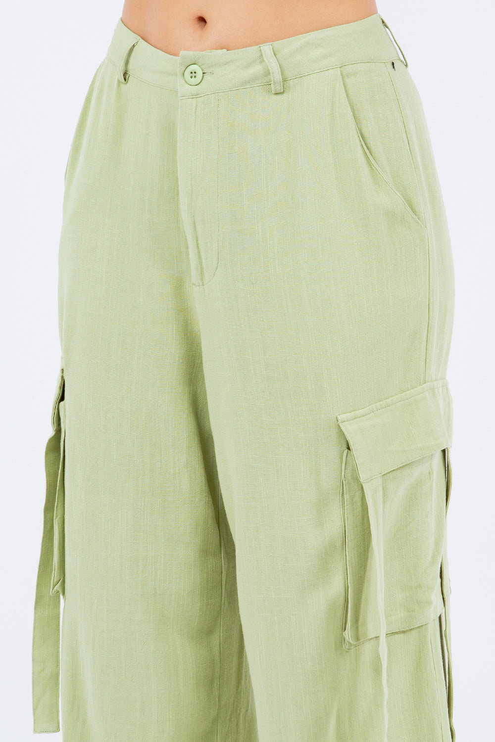 Light green linen wide leg cargo pants for women, versatile and breathable fabric, perfect for dressing up or down.