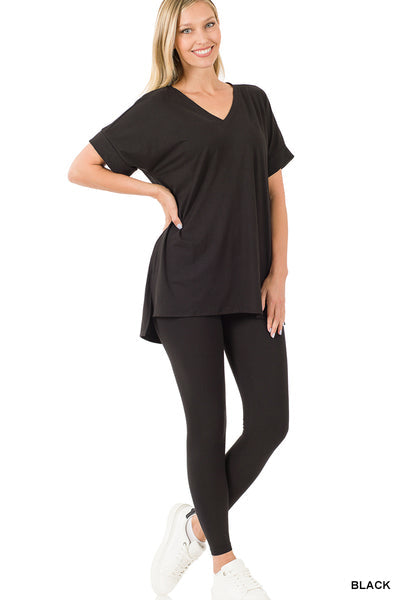 Woman wears black Lounge Around Two-Piece Set, comprising V-neck top and leggings, crafted from 90% polyester and 10% spandex.