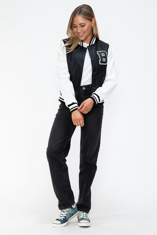 Woman wearing Love PU Leather Contrast Snap Down Bomber Jacket with black and white design, casual style.