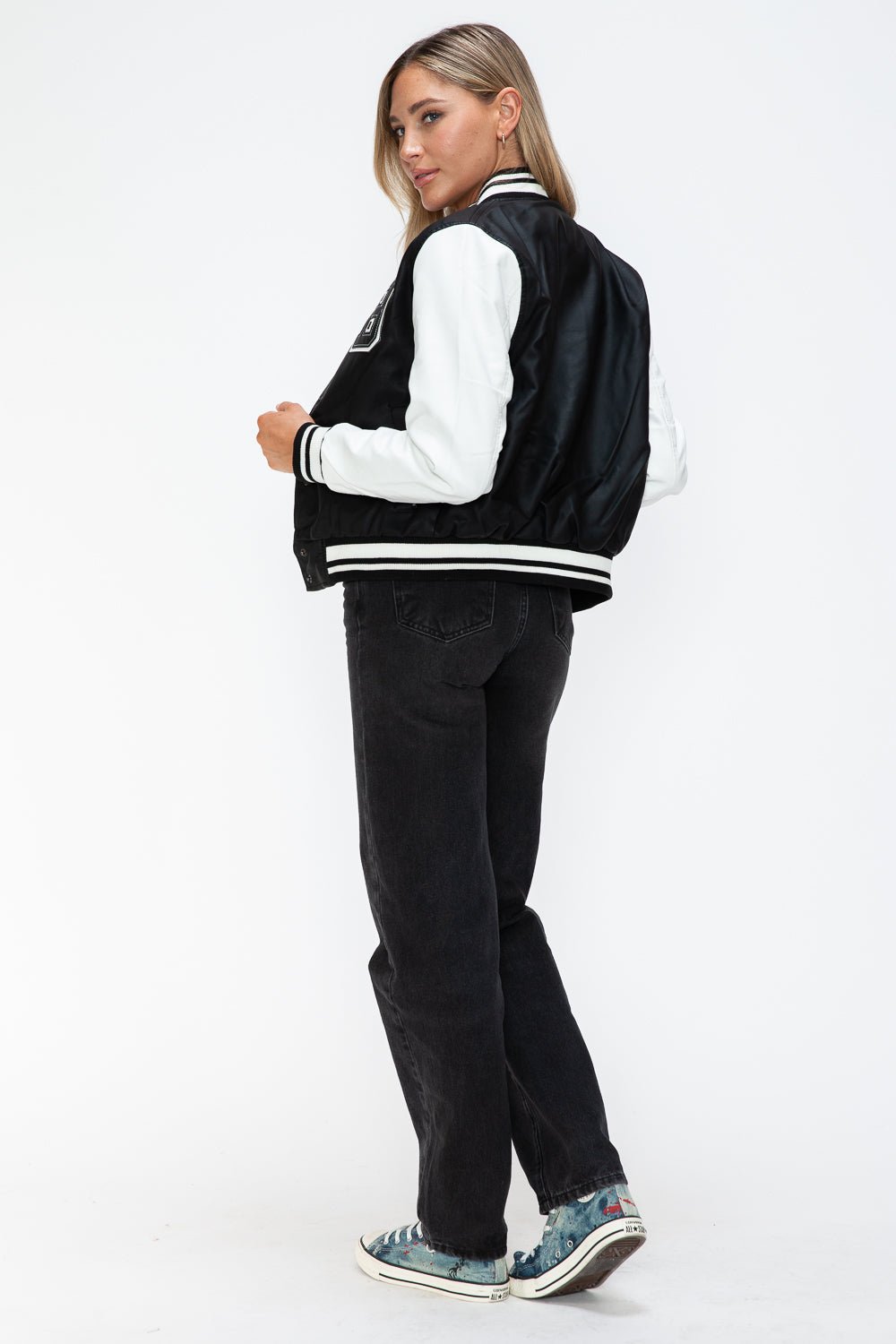 Woman wearing Love PU Leather Contrast Snap Down Bomber Jacket in black and white, showcasing stylish casual fashion.
