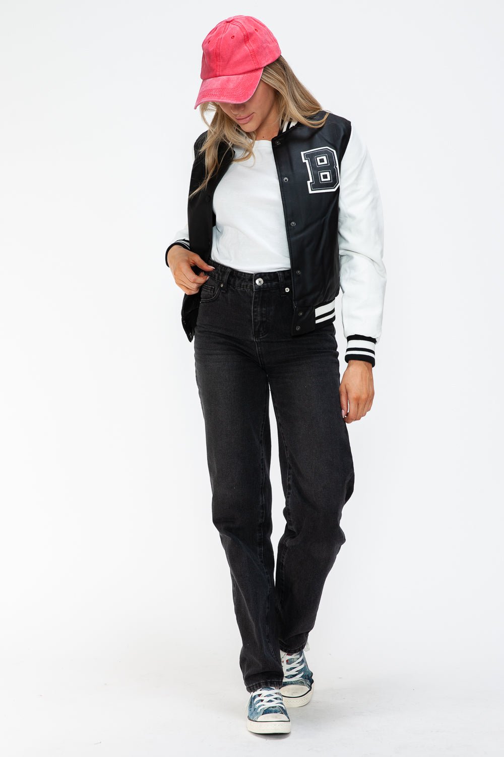 Woman wearing a Love PU Leather Contrast Snap Down Bomber Jacket with a red cap and sneakers.