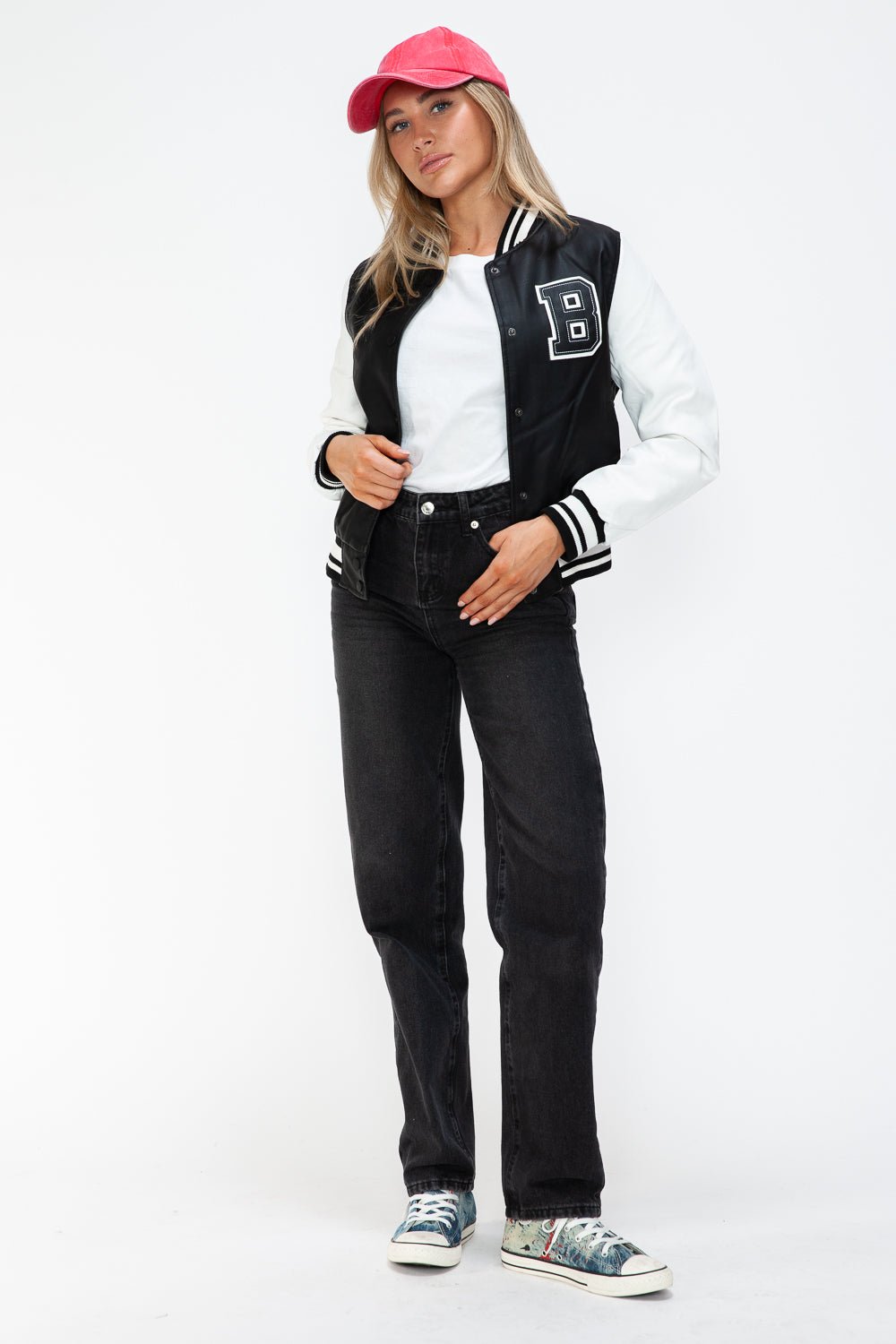 Woman wearing Love PU Leather Contrast Snap Down Bomber Jacket, white top, black jeans, and red cap, casual trendy style.