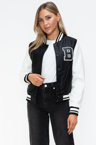 Woman wearing a Love PU Leather Contrast Snap Down Bomber Jacket in black and white with letter B on front.