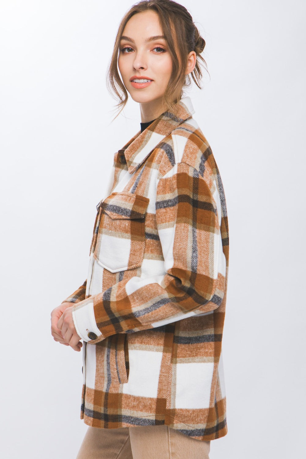 Woman wearing Love Tree Plaid Button Up Shacket, showcasing its chic design and cozy, durable material.