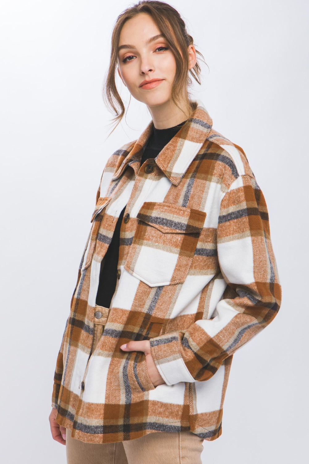 Woman wearing a Love Tree Plaid Button Up Shacket, showcasing a stylish blend of shirt and jacket with a classic plaid pattern.