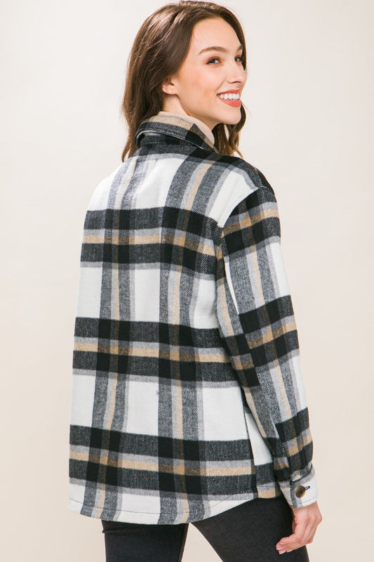 Woman wearing Love Tree Plaid Button Up Shacket showcasing back view with classic plaid pattern and button-up design.