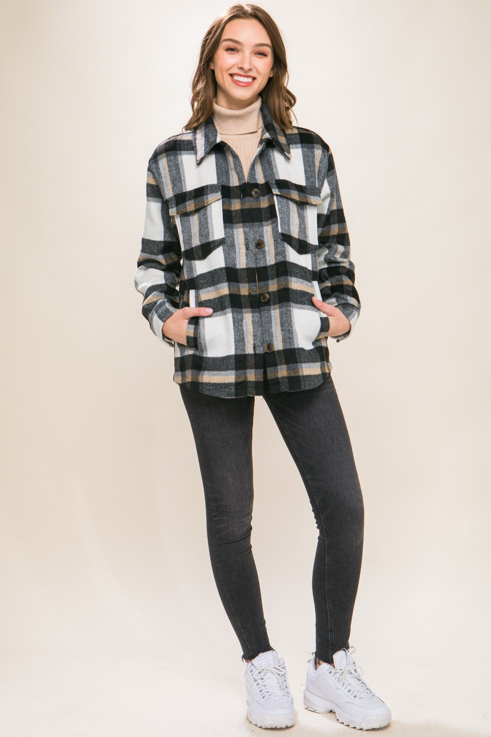 Woman wearing Love Tree Plaid Button Up Shacket casually styled with jeans and sneakers, showcasing chic and versatile fashion.