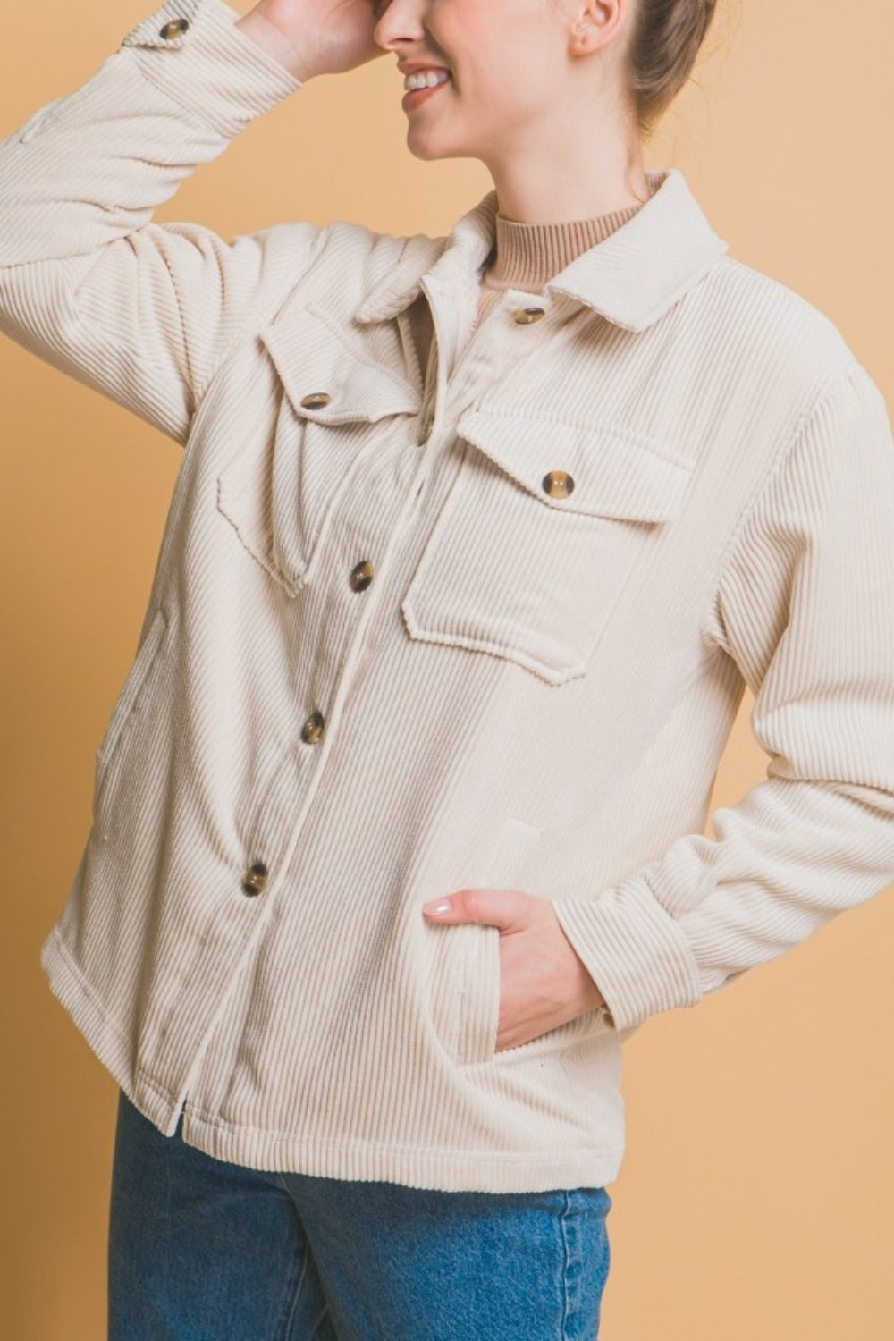 Woman wearing a Love Tree Corduroy Button Up Jacket with Sherpa lining, showcasing cozy style and warmth, perfect for layering.