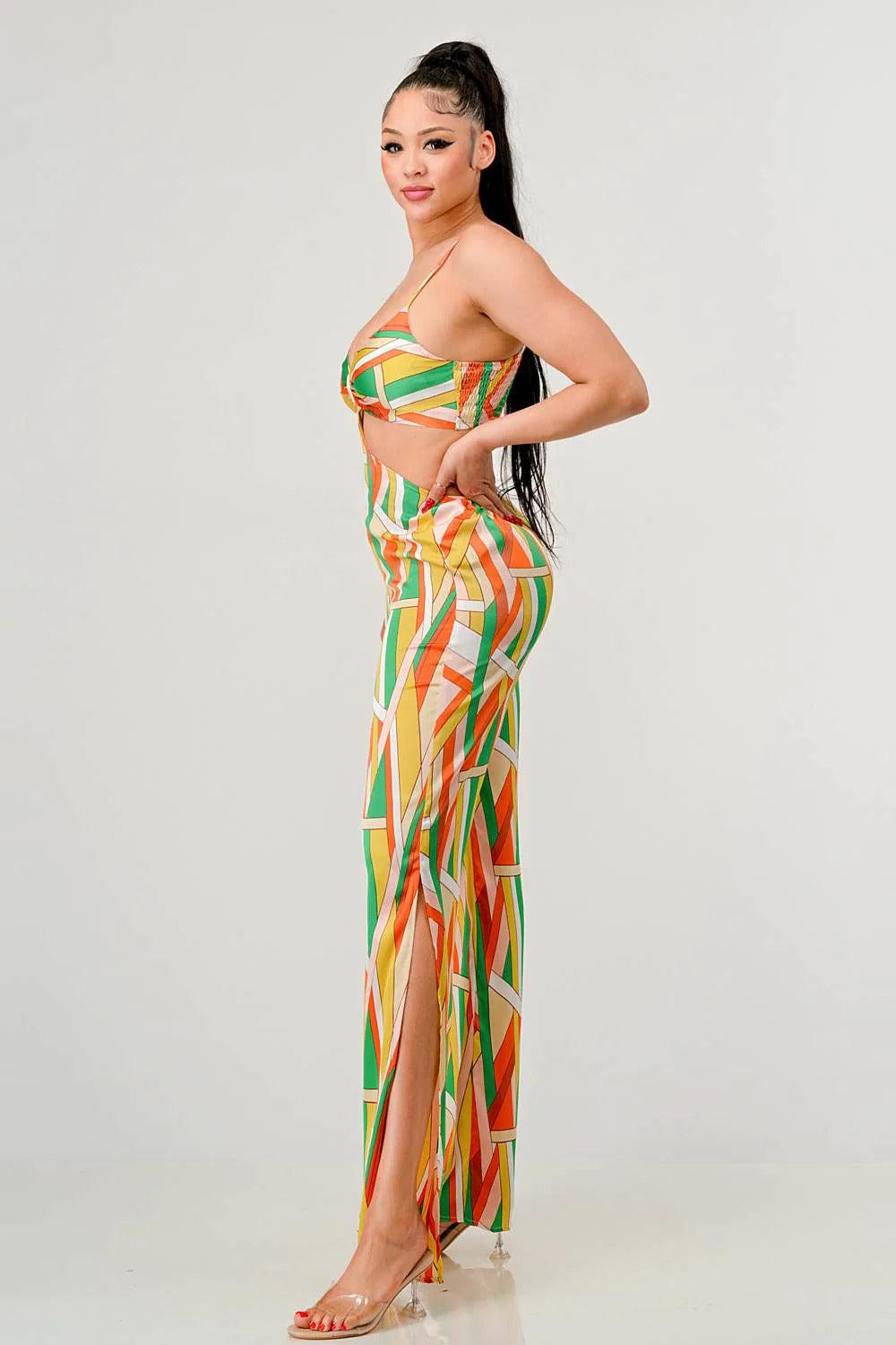 Woman wearing orange multi print satin bra top and palazzo jumpsuit with geo pattern, side view.